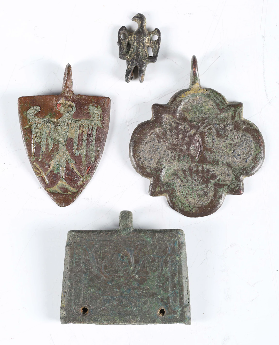 A medieval copper alloy heraldic shield-shaped pendant, length 4.5cm