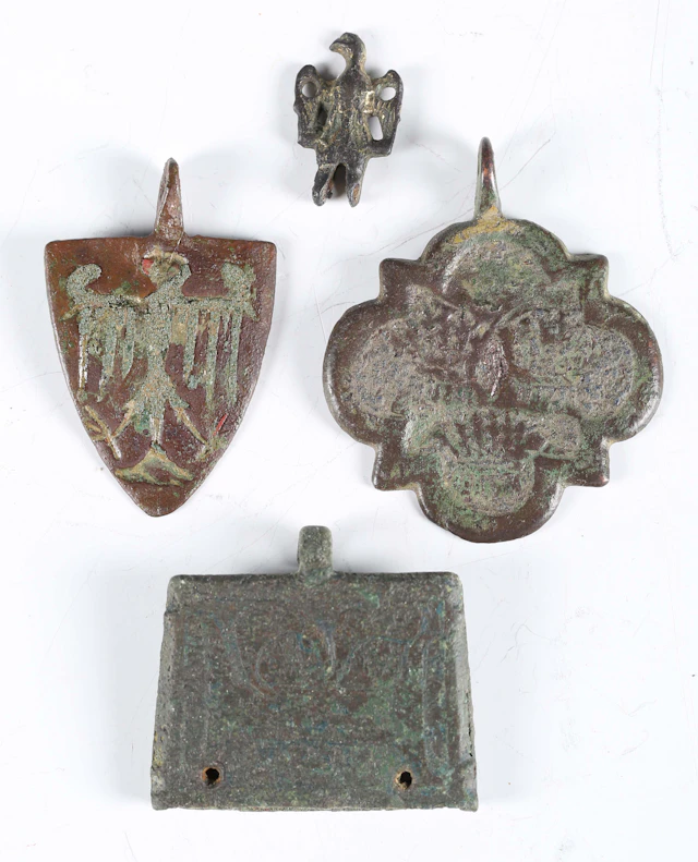 A medieval copper alloy heraldic shield-shaped pendant, length 4.5cm