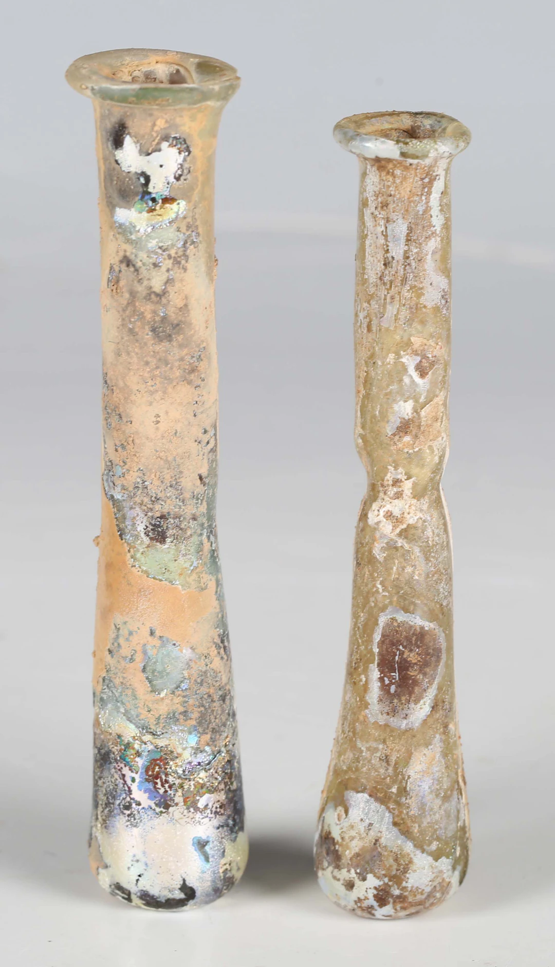 Two ancient Roman glass ungentarium bottles with slightly out-turned