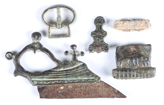 A small group of antiquities, including an ancient Roman razor with