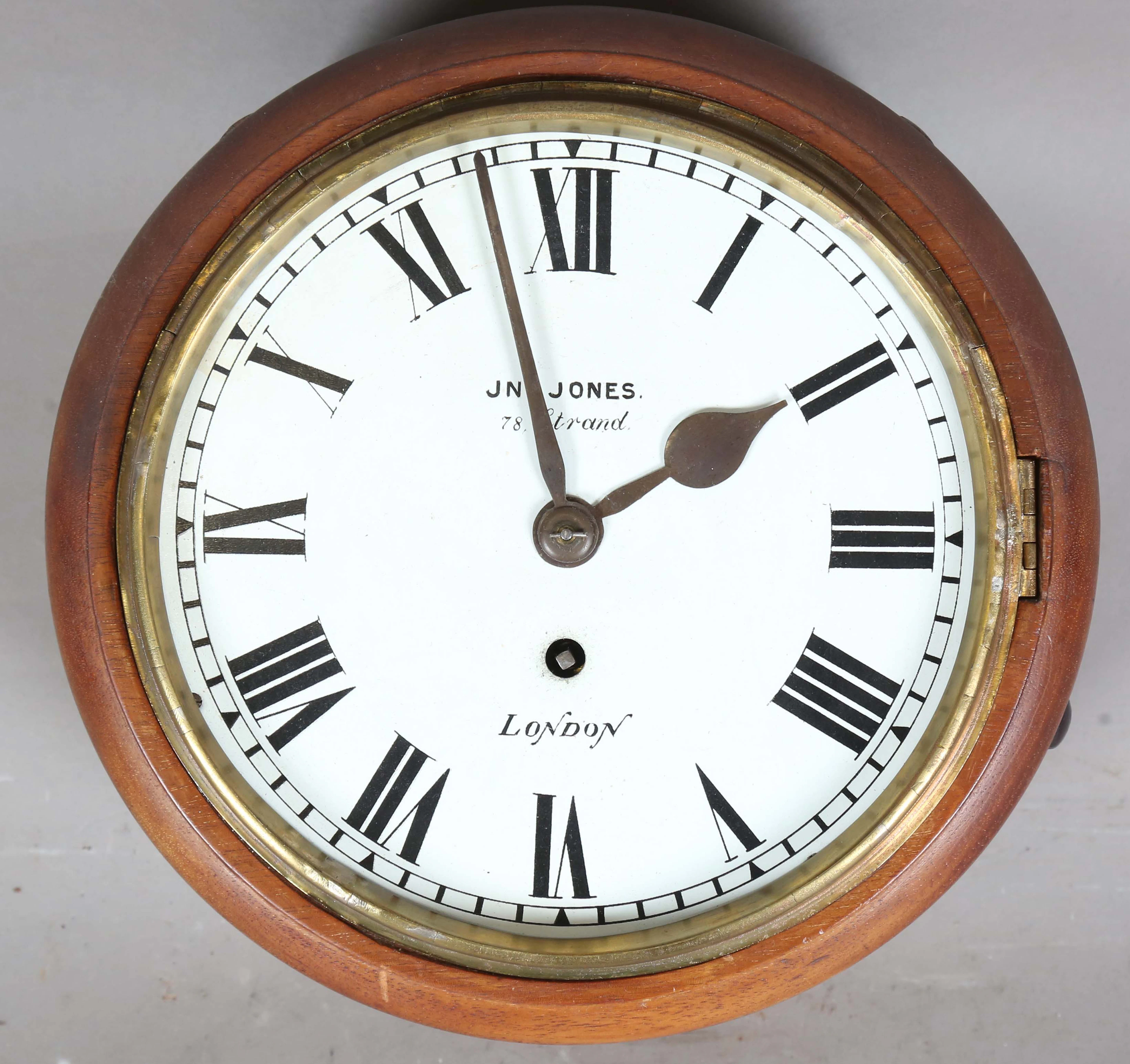 An early 20th century mahogany circular wall timepiece with brass