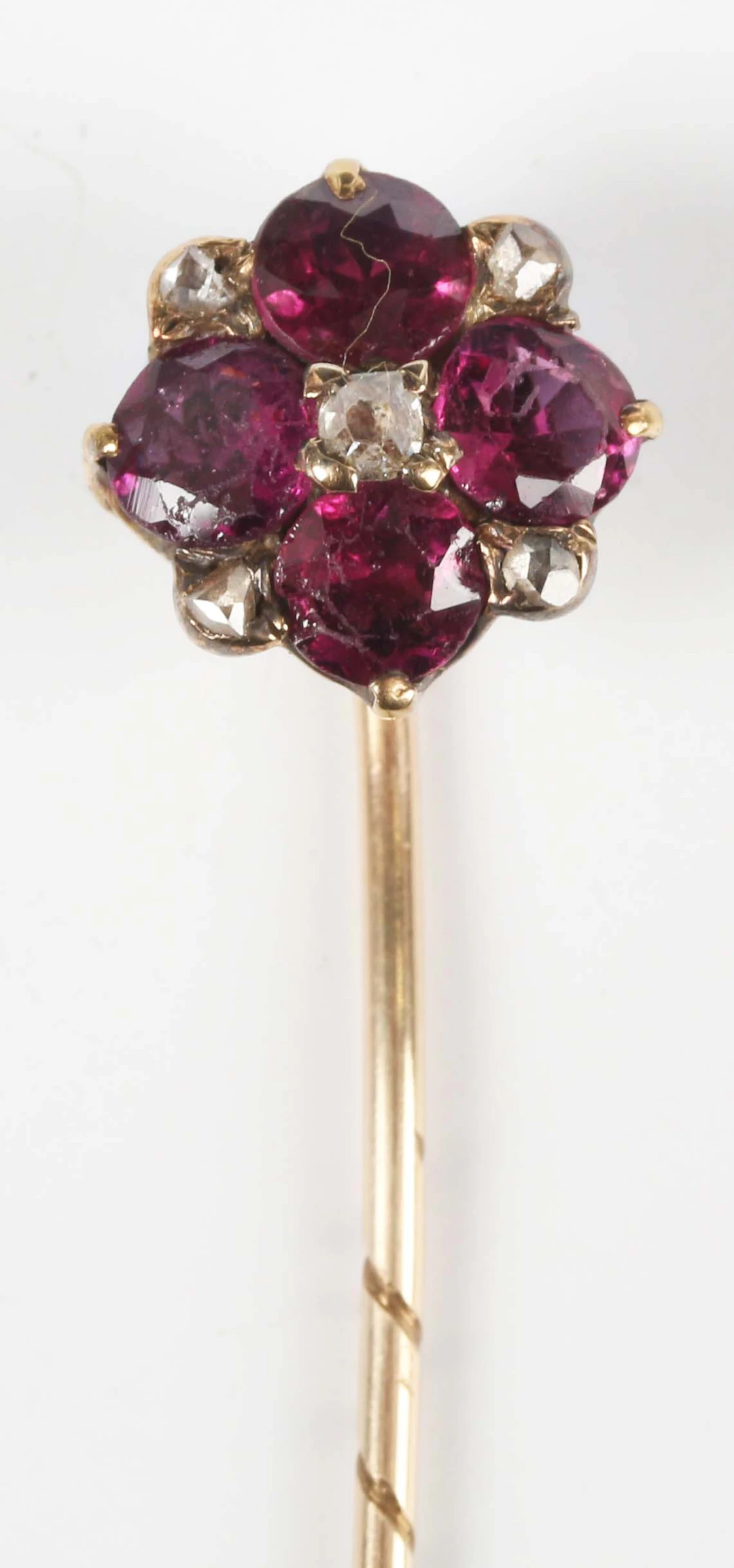 A Victorian gold, garnet and diamond cluster stickpin, unmarked, weight