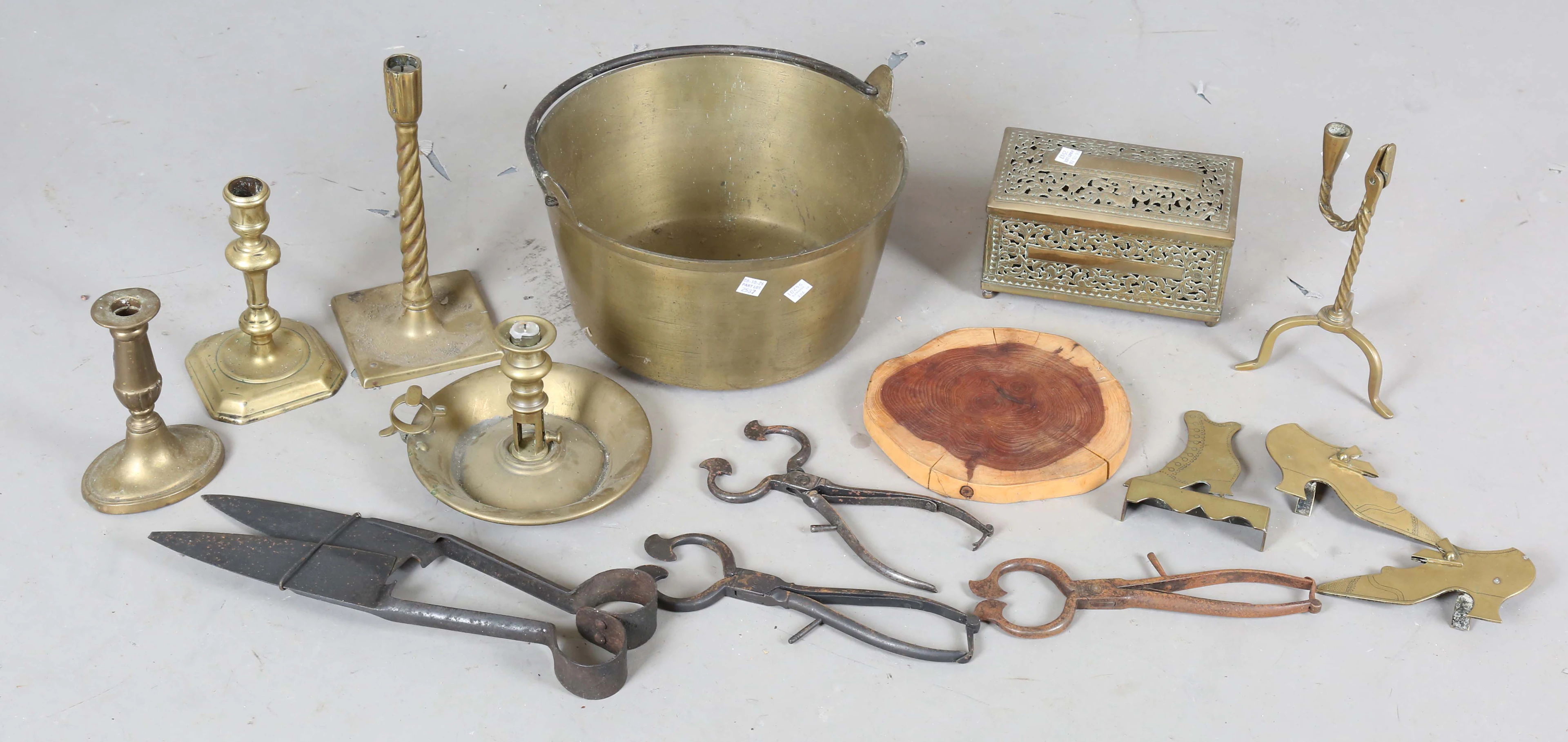 An 18th century brass rush light and candle holder, on tripod legs
