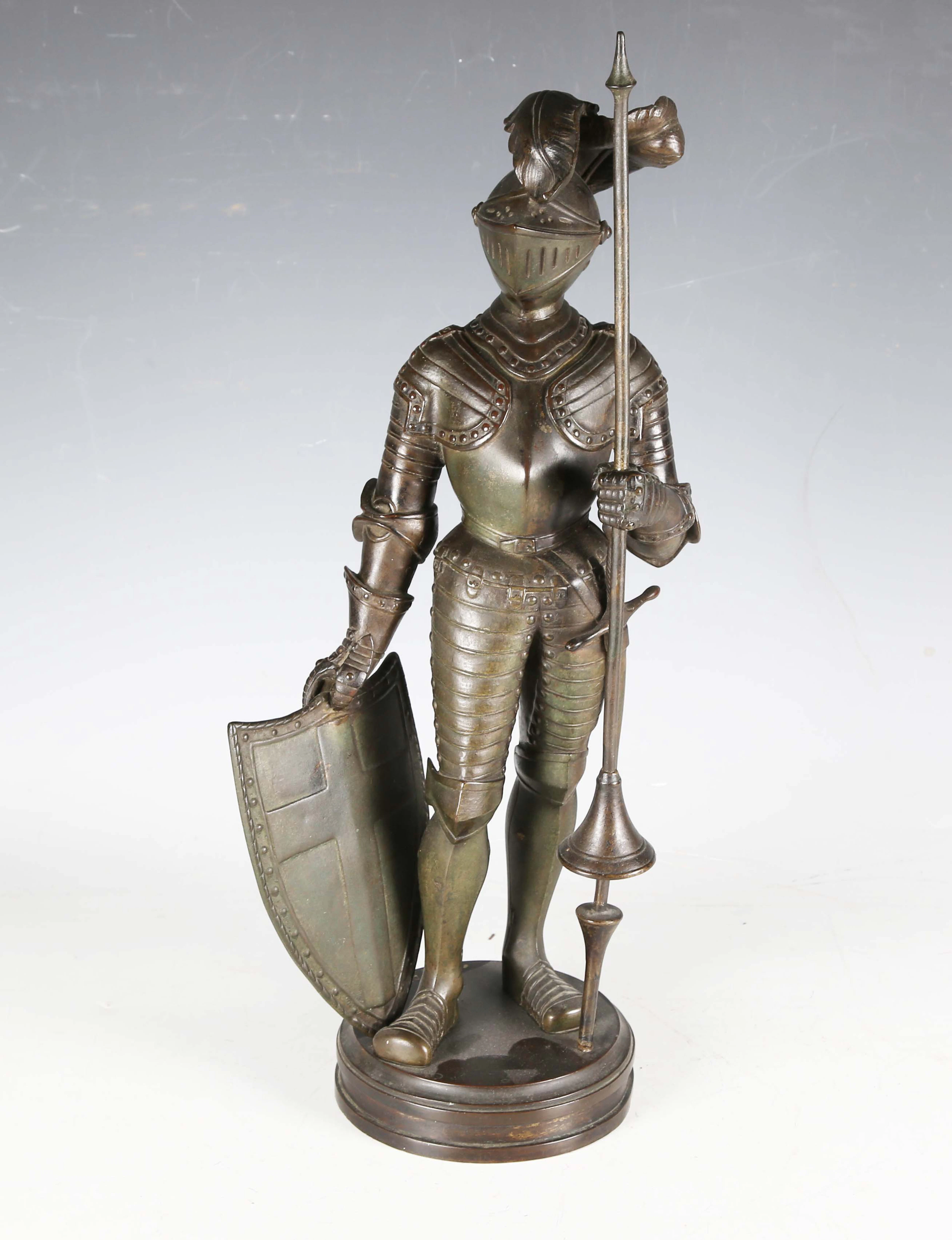 A late 19th century brown patinated cast bronze figure of a standing