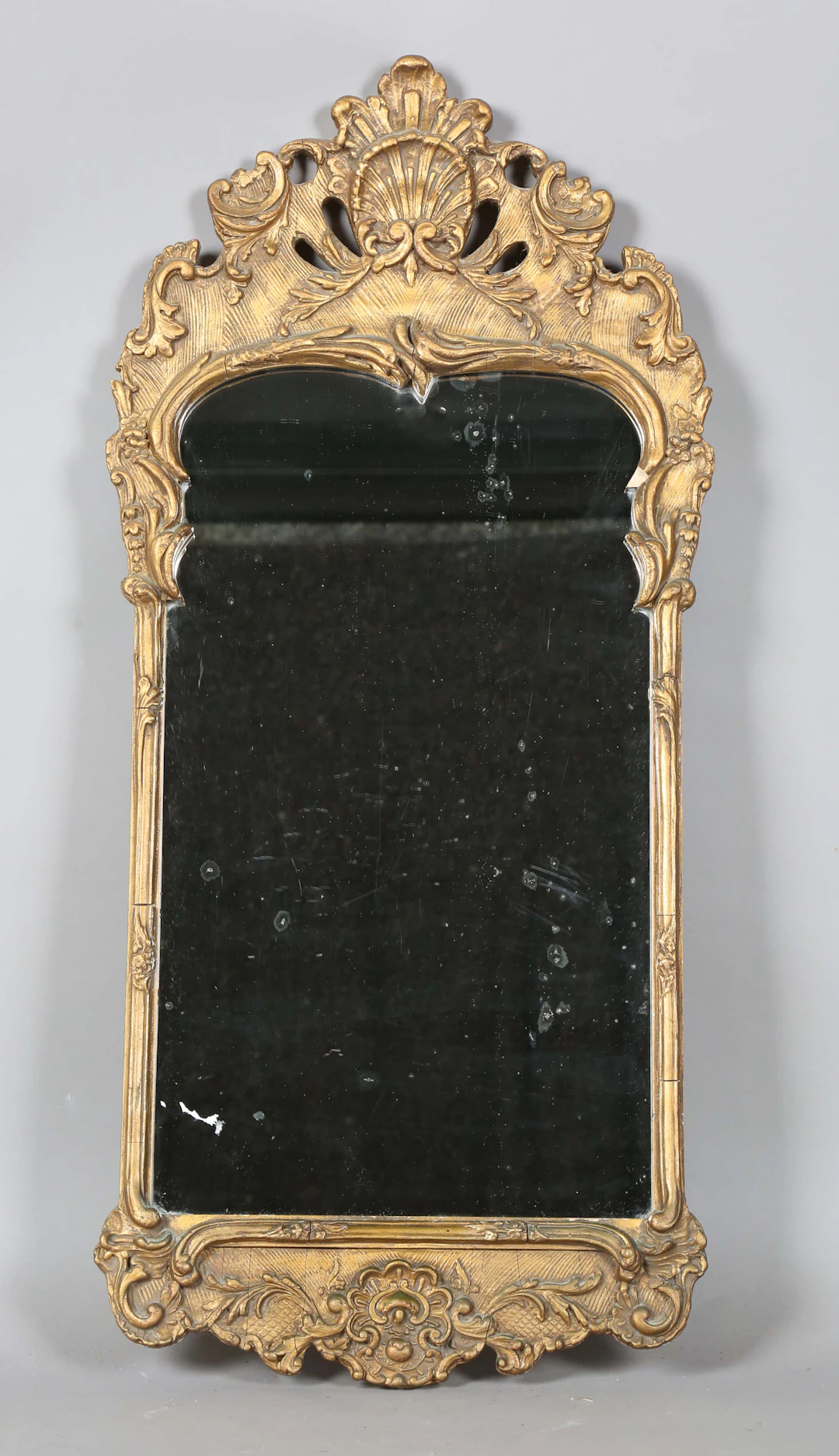 A 20th century Rococo style gilt composition wall mirror, the frame