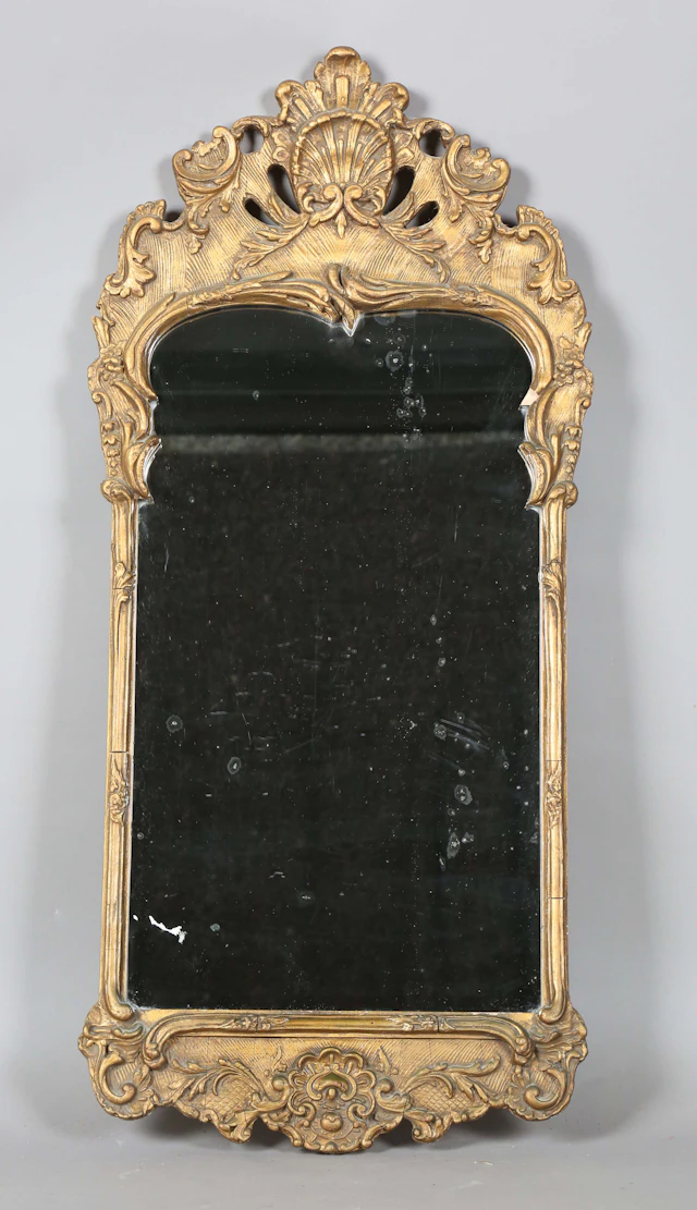 A 20th century Rococo style gilt composition wall mirror, the frame