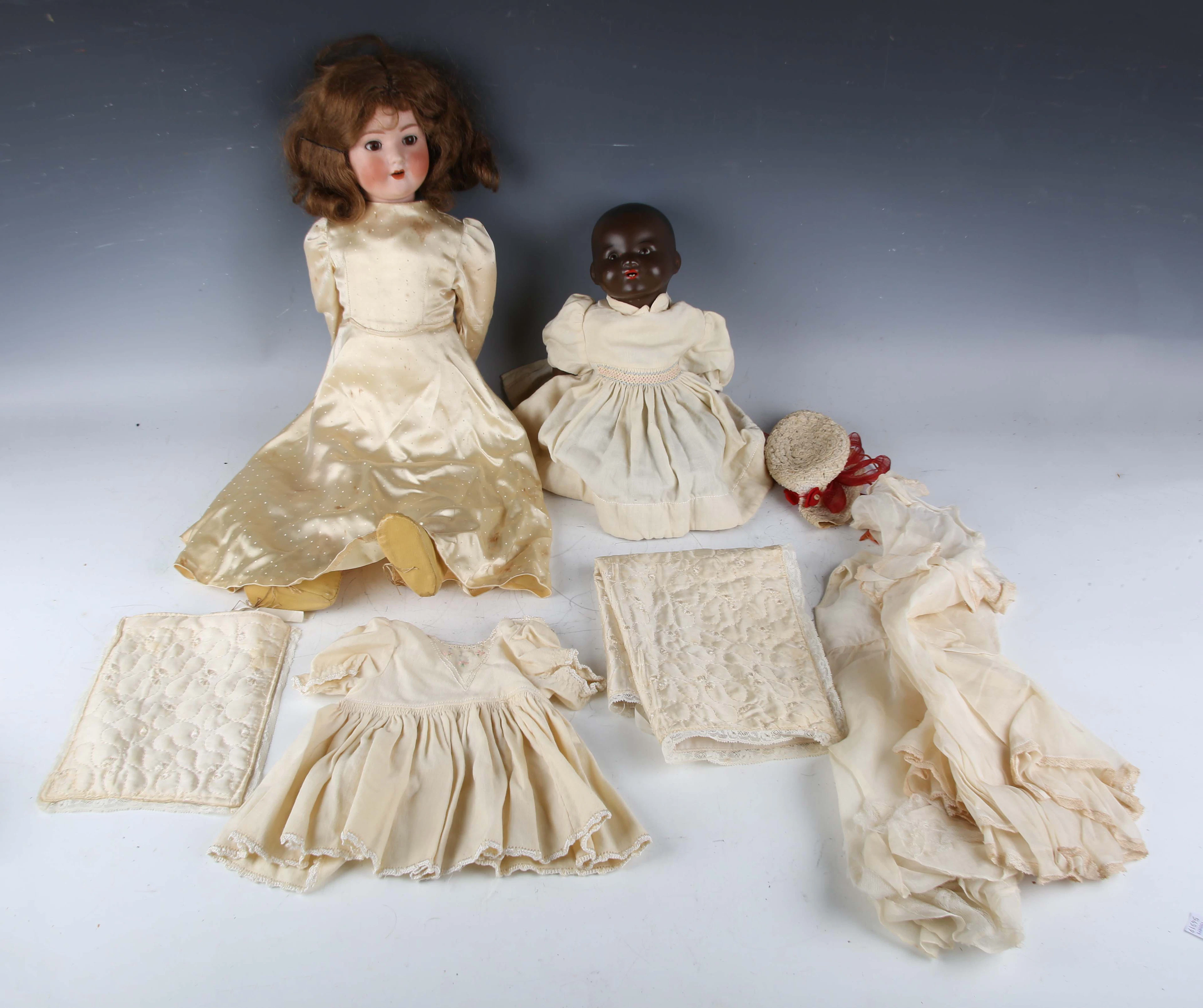 A Schoenau & Hoffmeister bisque head doll, impressed '1909-4½', with