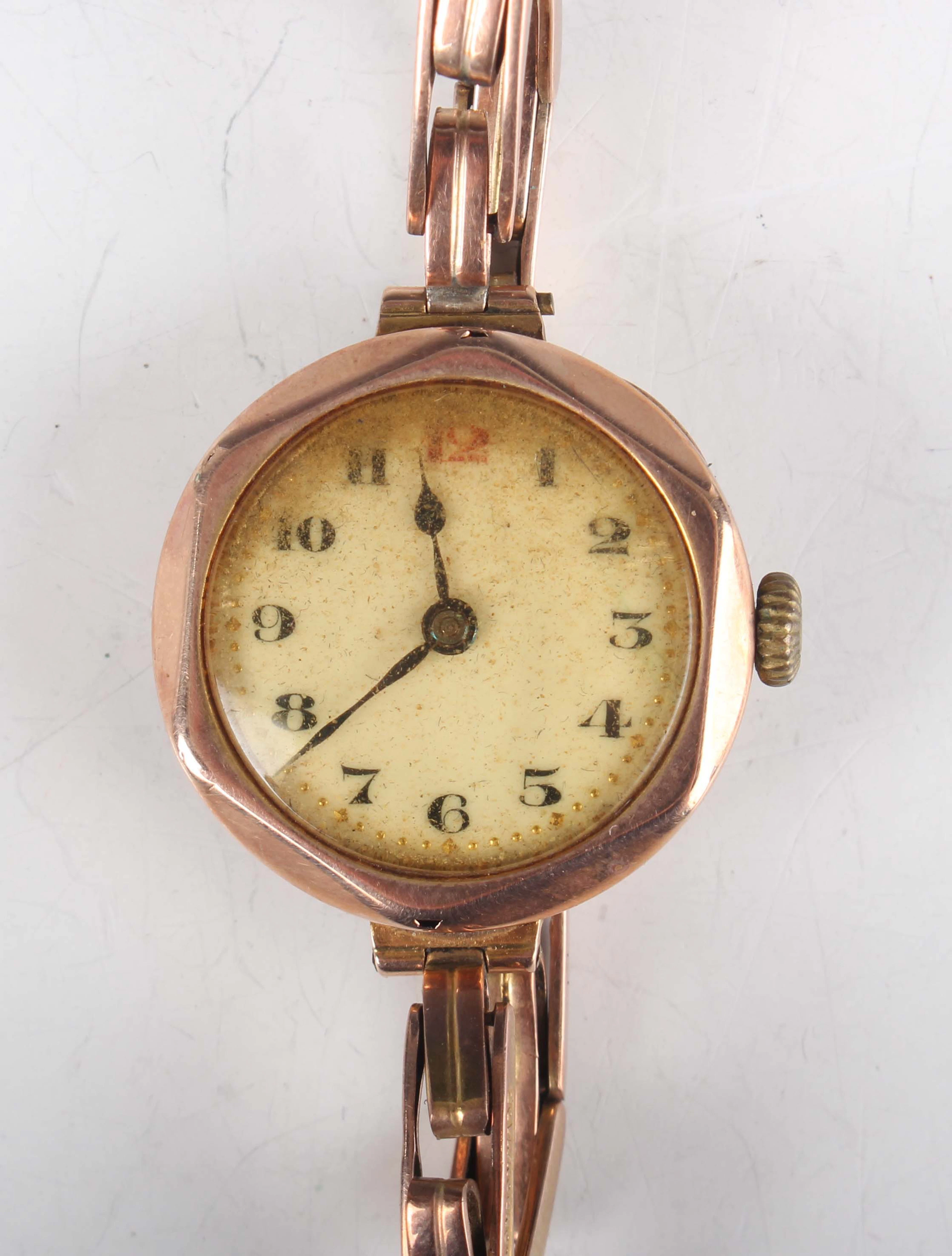 A 9ct gold faceted circular cased lady's wristwatch with unsigned