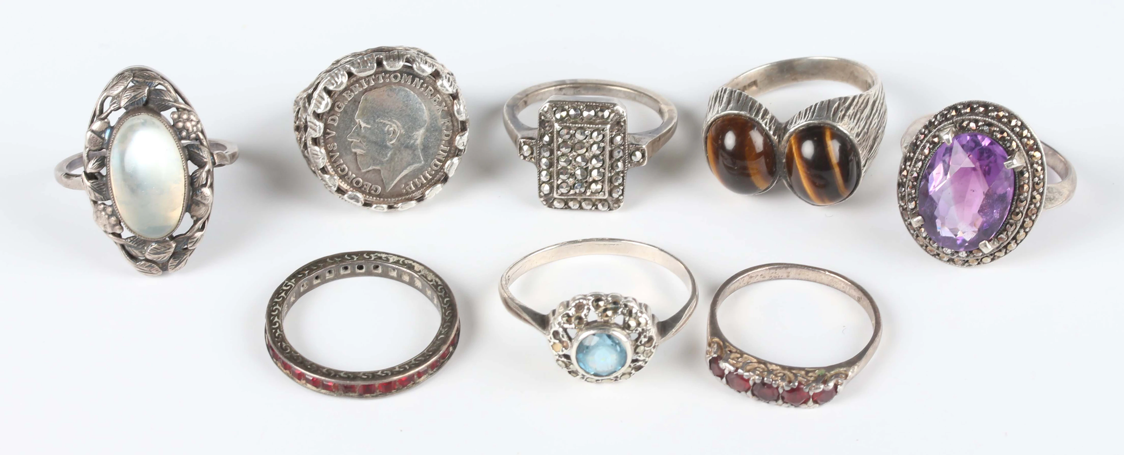 Four silver and gem set rings, total weight 14.1g, a silver and marcasite