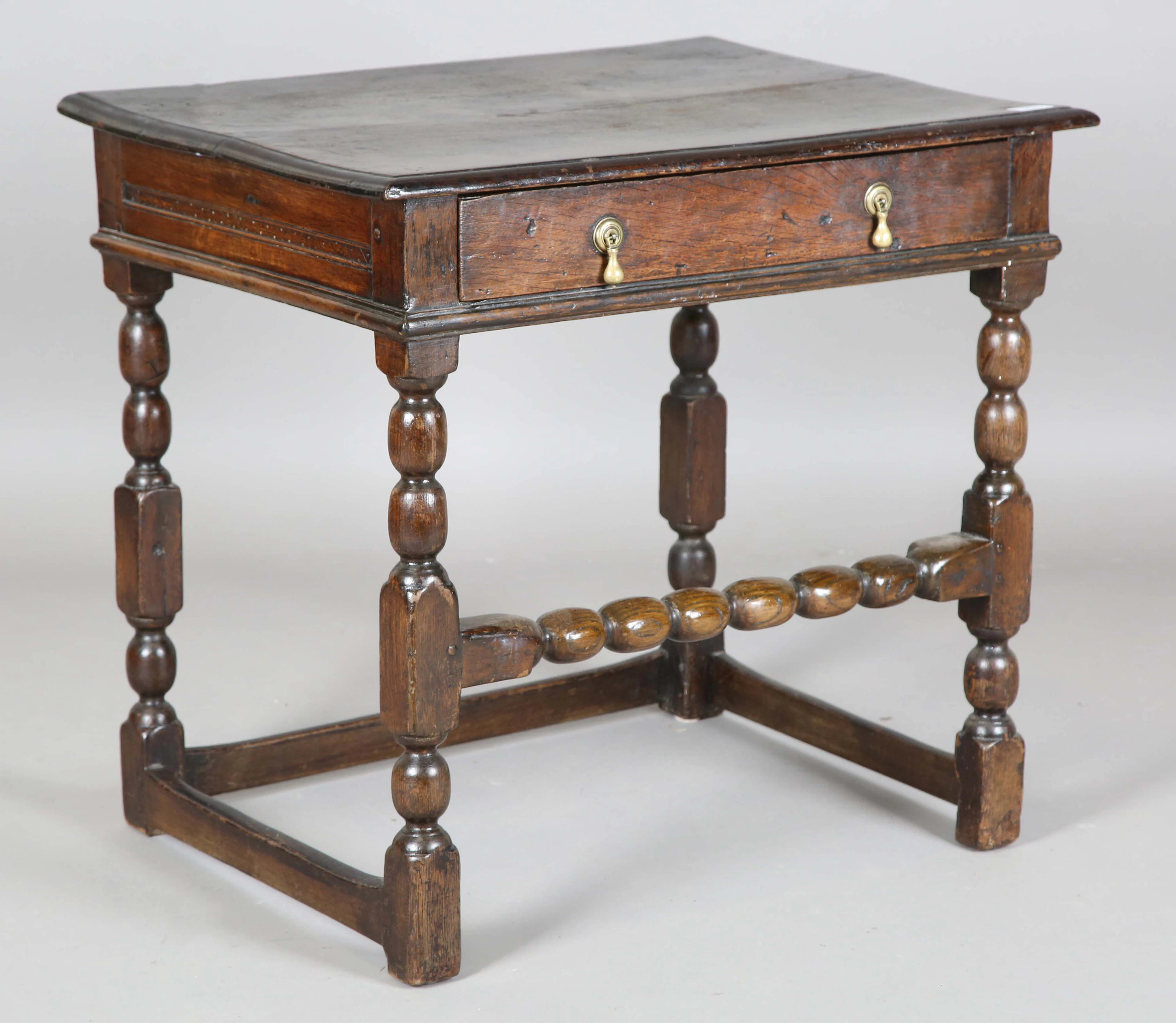 A Charles II oak side table, fitted with a single frieze drawer, on