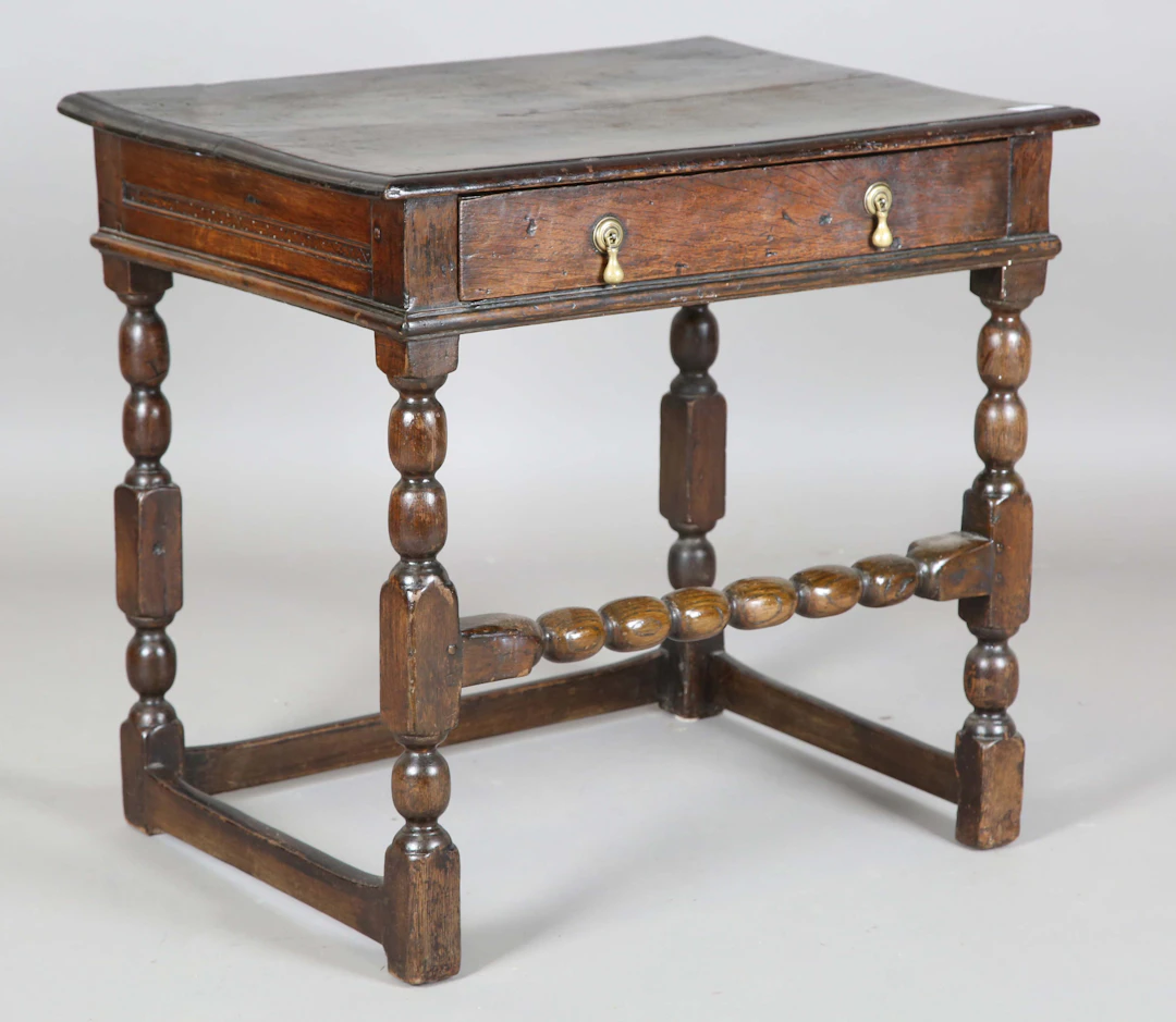 A Charles II oak side table, fitted with a single frieze drawer, on