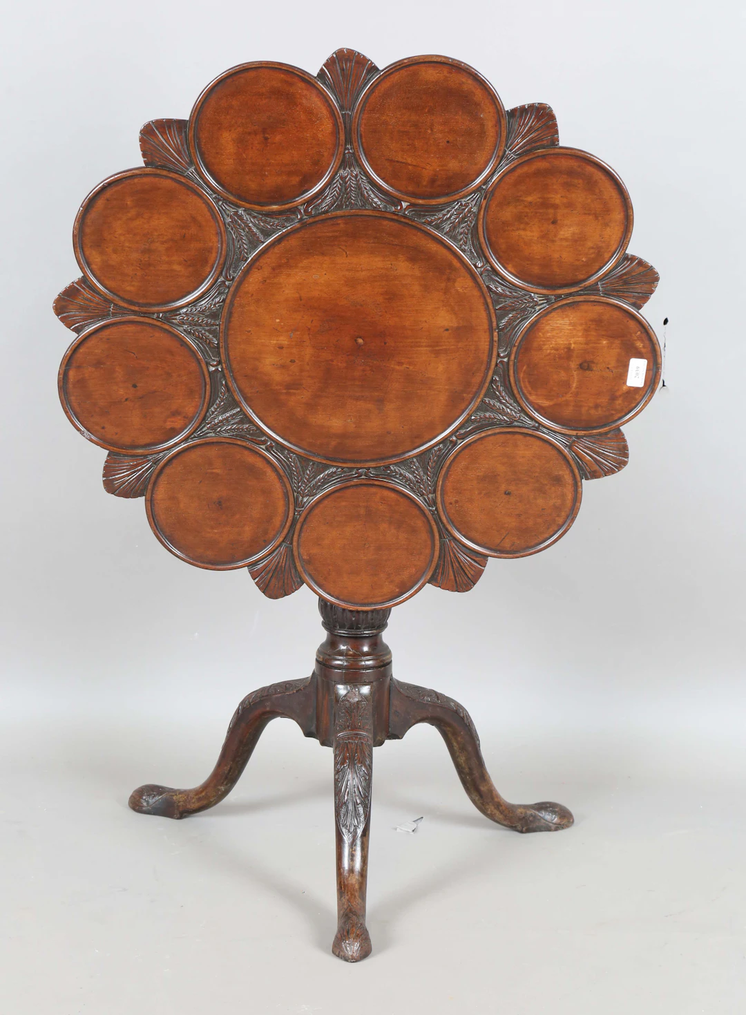 A George III mahogany tip-top supper table, the top later carved with