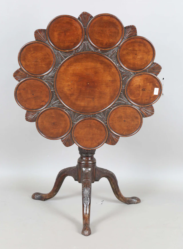A George III mahogany tip-top supper table, the top later carved with