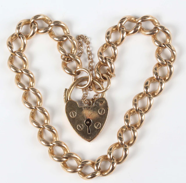 A 9ct gold curblink bracelet on a 9ct gold heart shaped padlock clasp