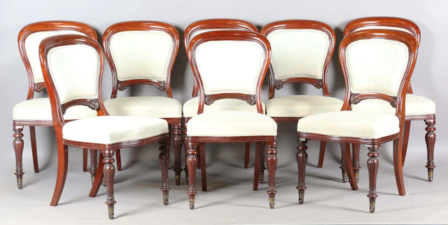A good set of eight mid-Victorian mahogany showframe spoon back dining