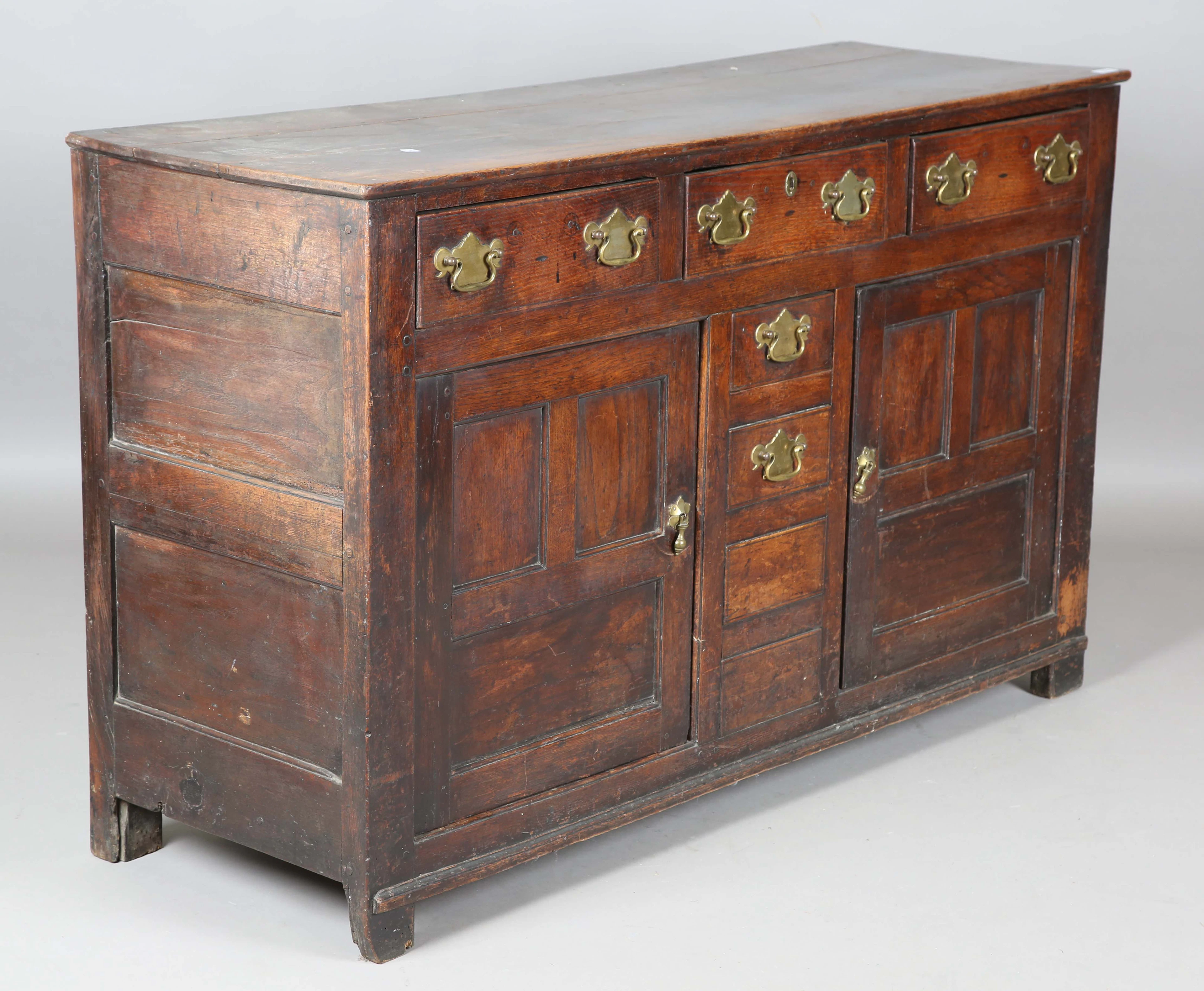 An 18th century oak dresser base, fitted with an arrangement of drawers