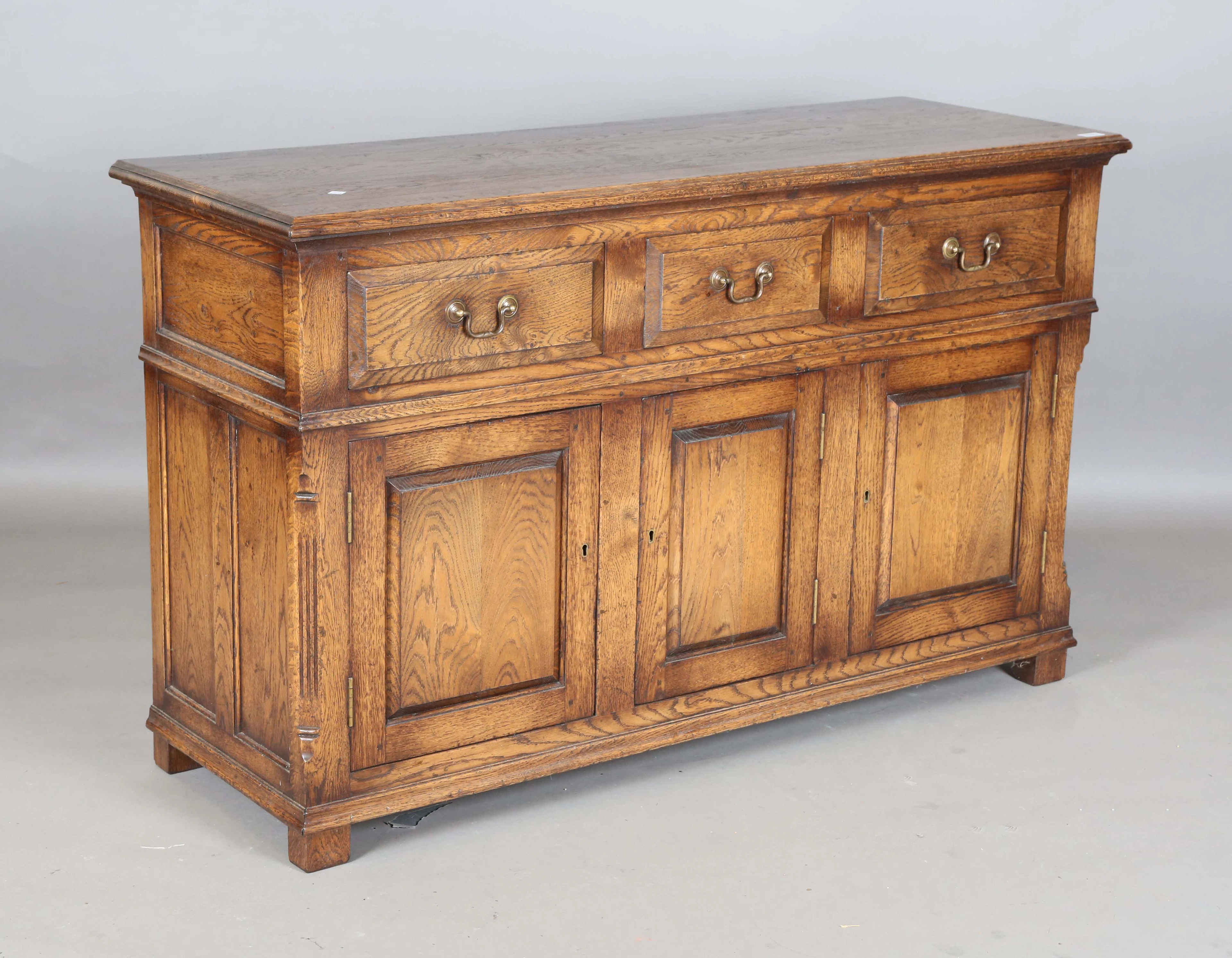 A 20th century George III style oak dresser base, fitted with three