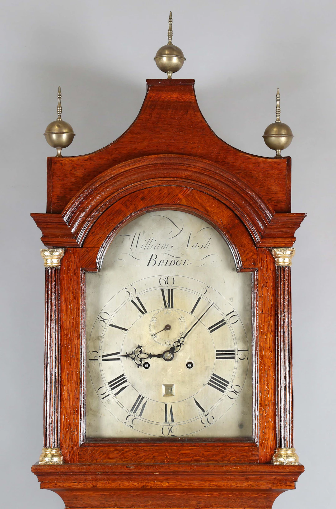 A George III oak longcase clock with eight day movement striking on