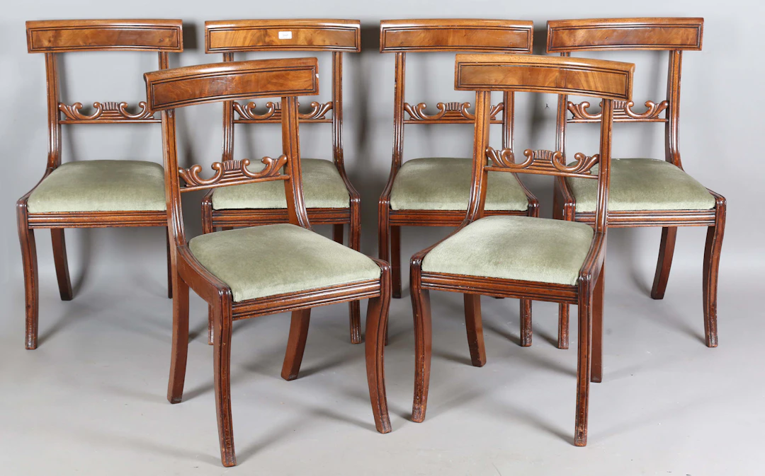 A set of six George IV mahogany bar back dining chairs with green