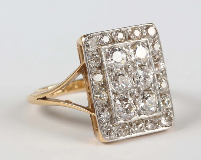 A gold, platinum and diamond rectangular cluster ring, mounted with
