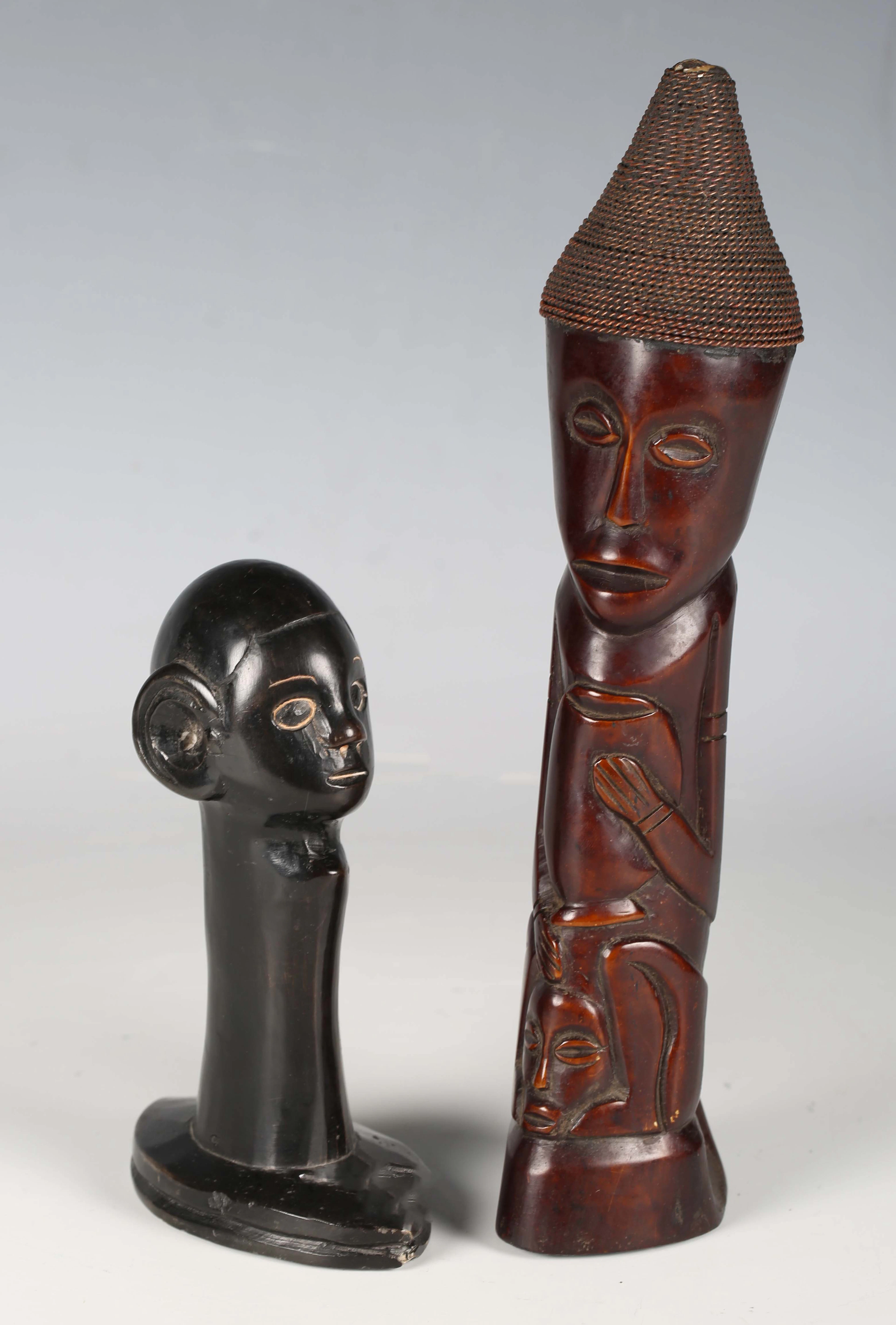 An African carved and stained bone figure group with bound wire headdress