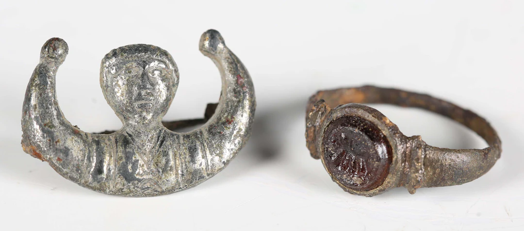 An ancient Roman silvered alloy figural brooch, formed as the head