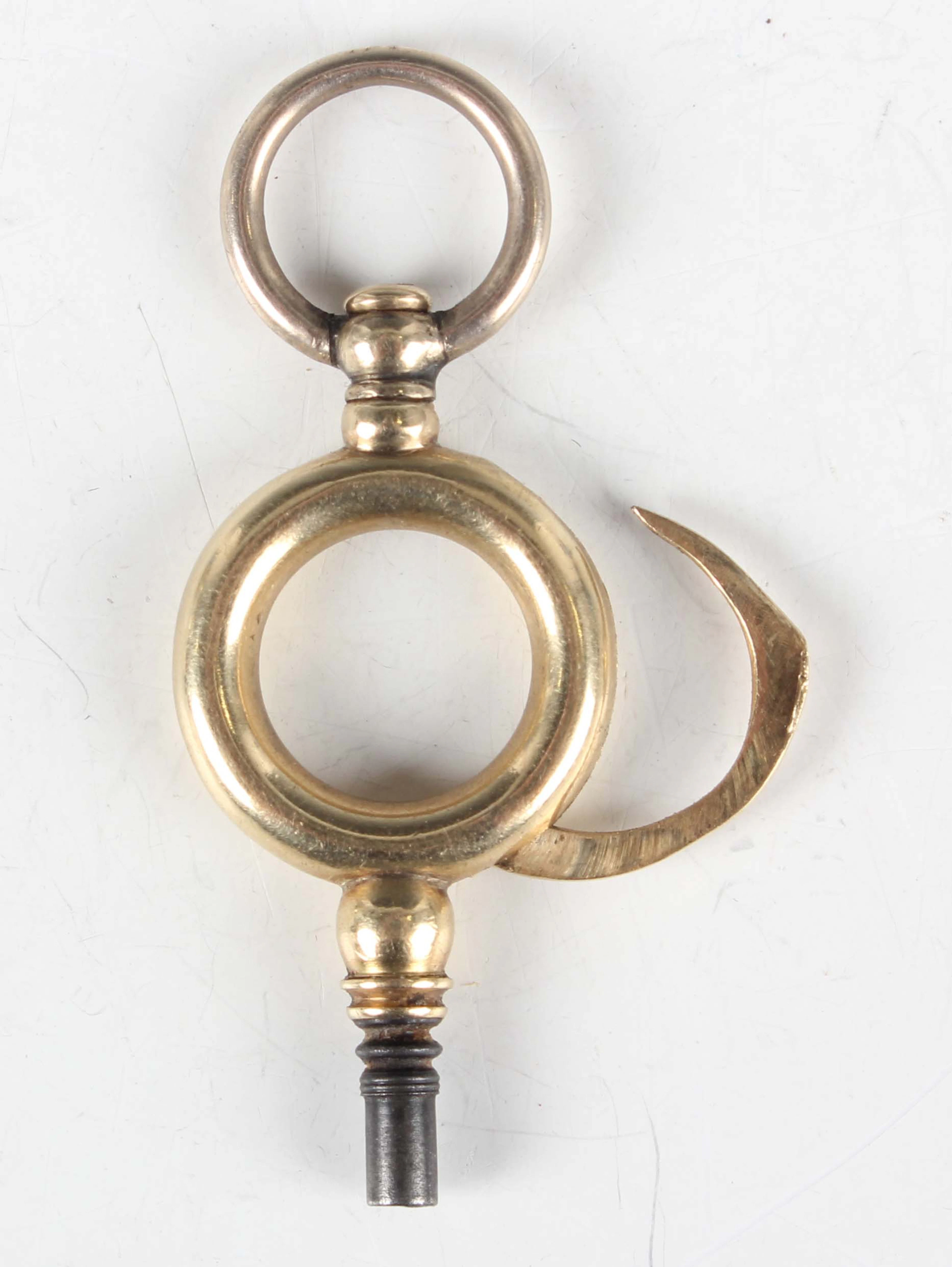 A 19th century gold pocket watch key, the central ring with concealed