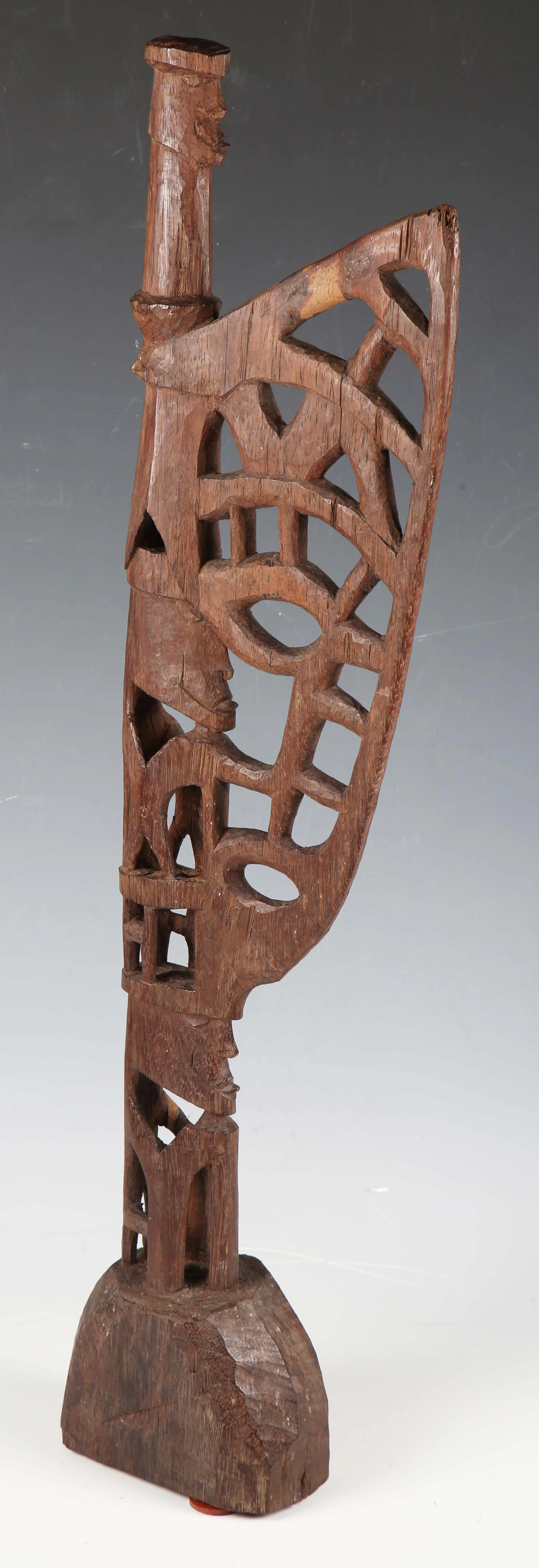A Mimika carved hardwood miniature Mbitoro ceremonial pole, Western