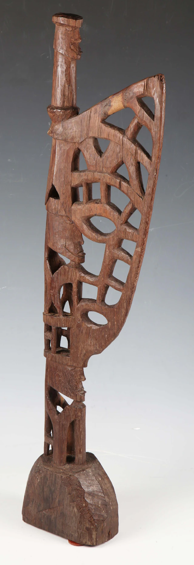 A Mimika carved hardwood miniature Mbitoro ceremonial pole, Western