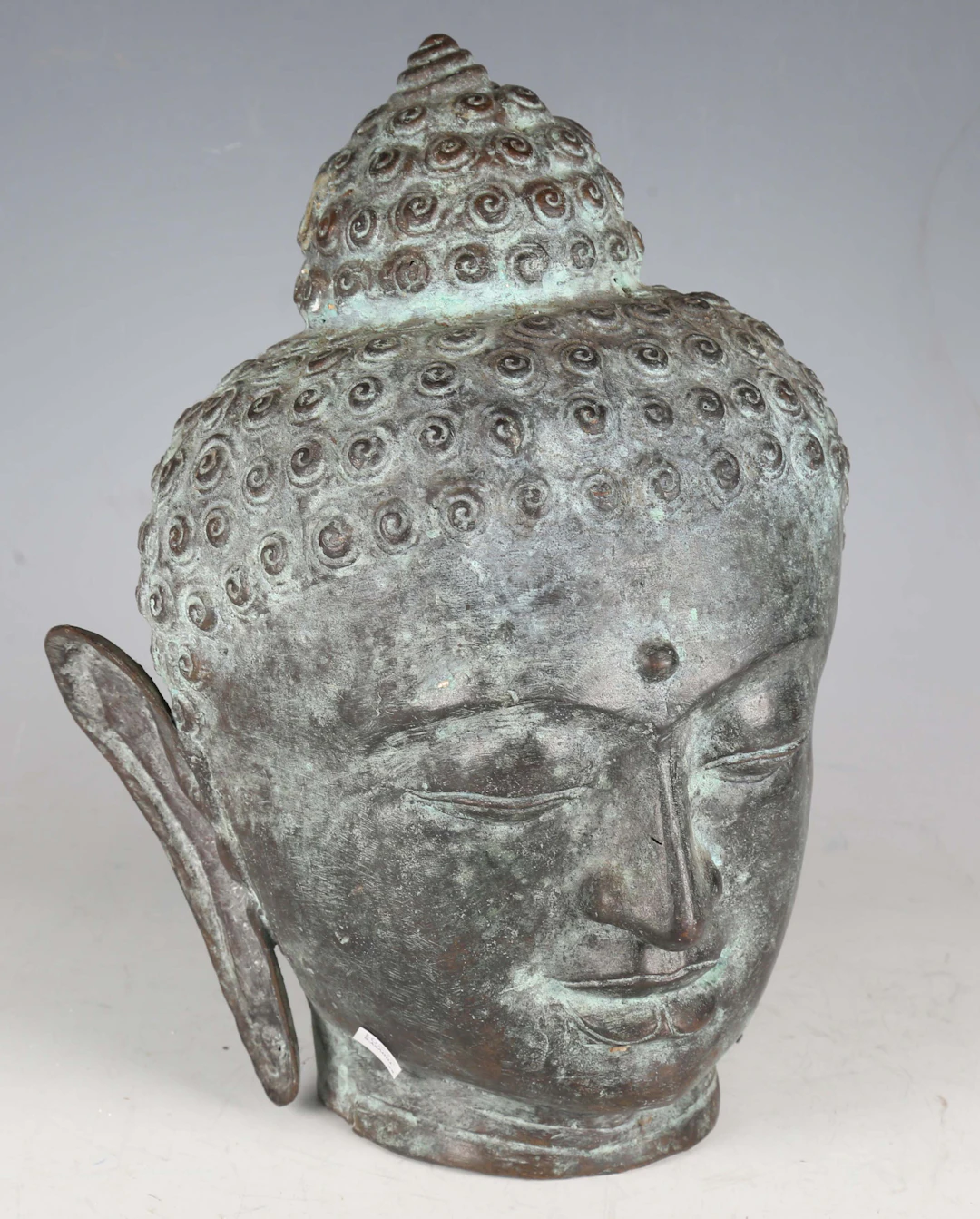 A South-east Asian verdigris bronze head of a Buddha, height 33cm.