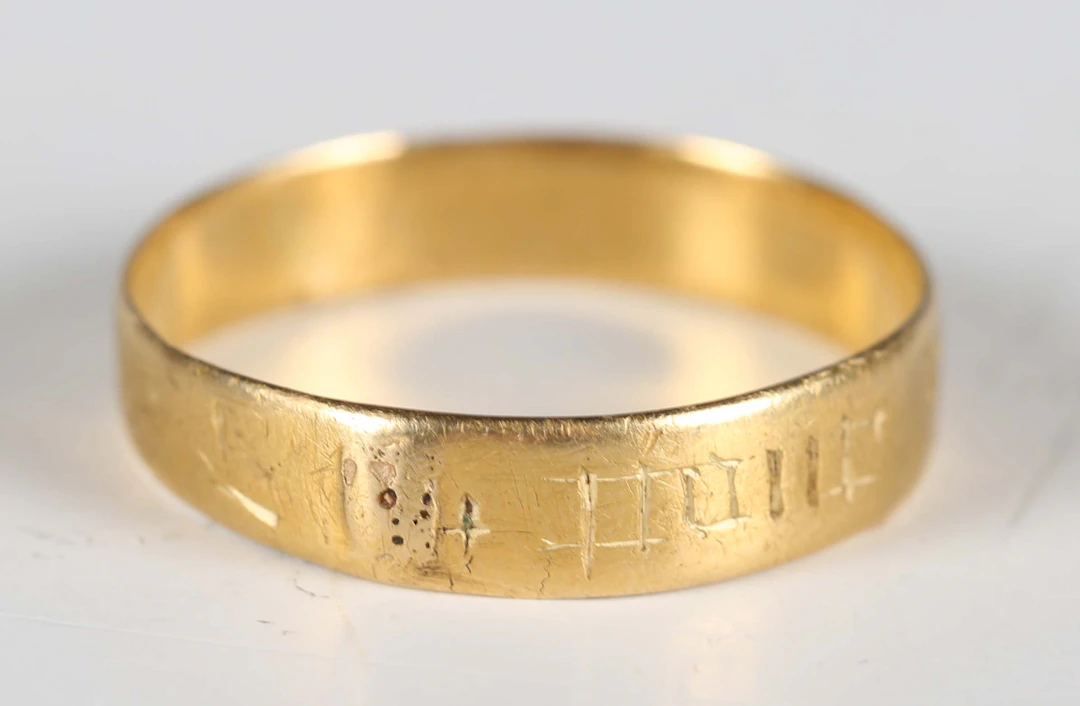 A 16th century gold posy ring, indistinctly engraved to the outside