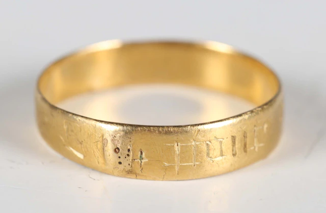 A 16th century gold posy ring, indistinctly engraved to the outside