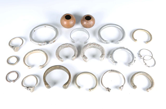 A collection of African manilla style currency bangles, including