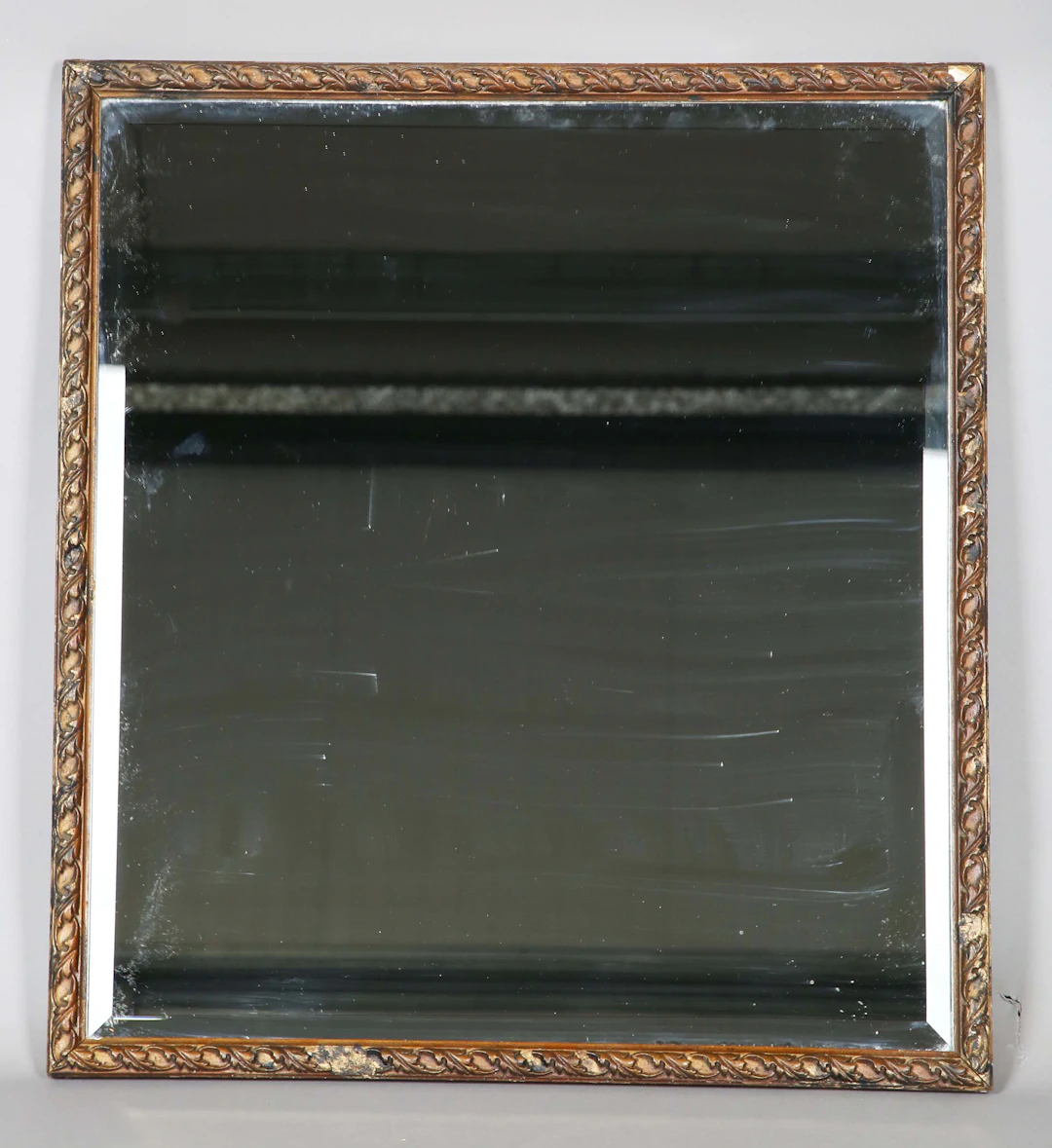 An early 20th century gilt composition rectangular wall mirror with