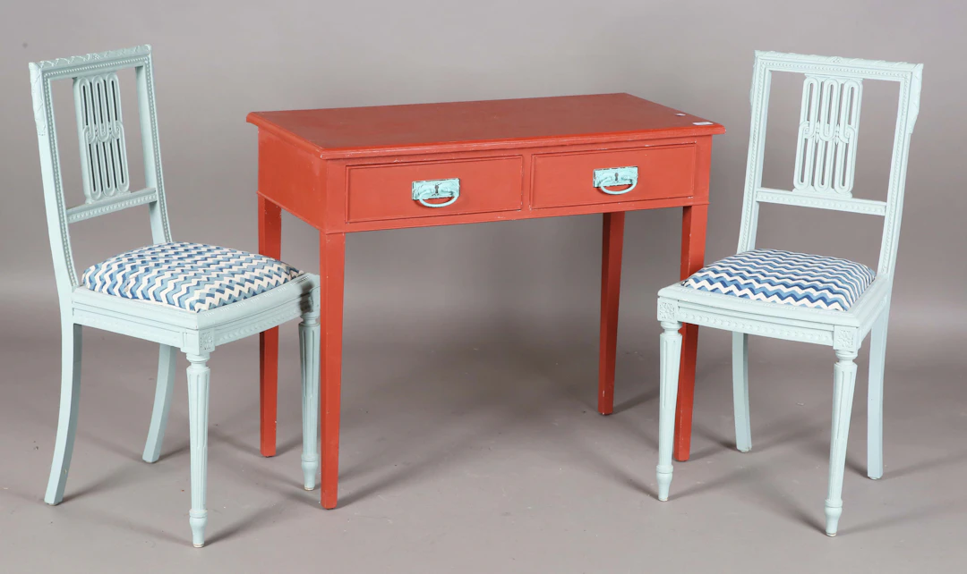 A 20th century red painted side table, fitted with two drawers, height