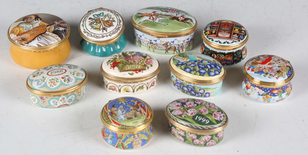 A group of eight Halcyon Days enamel boxes and two similar enamel boxes.