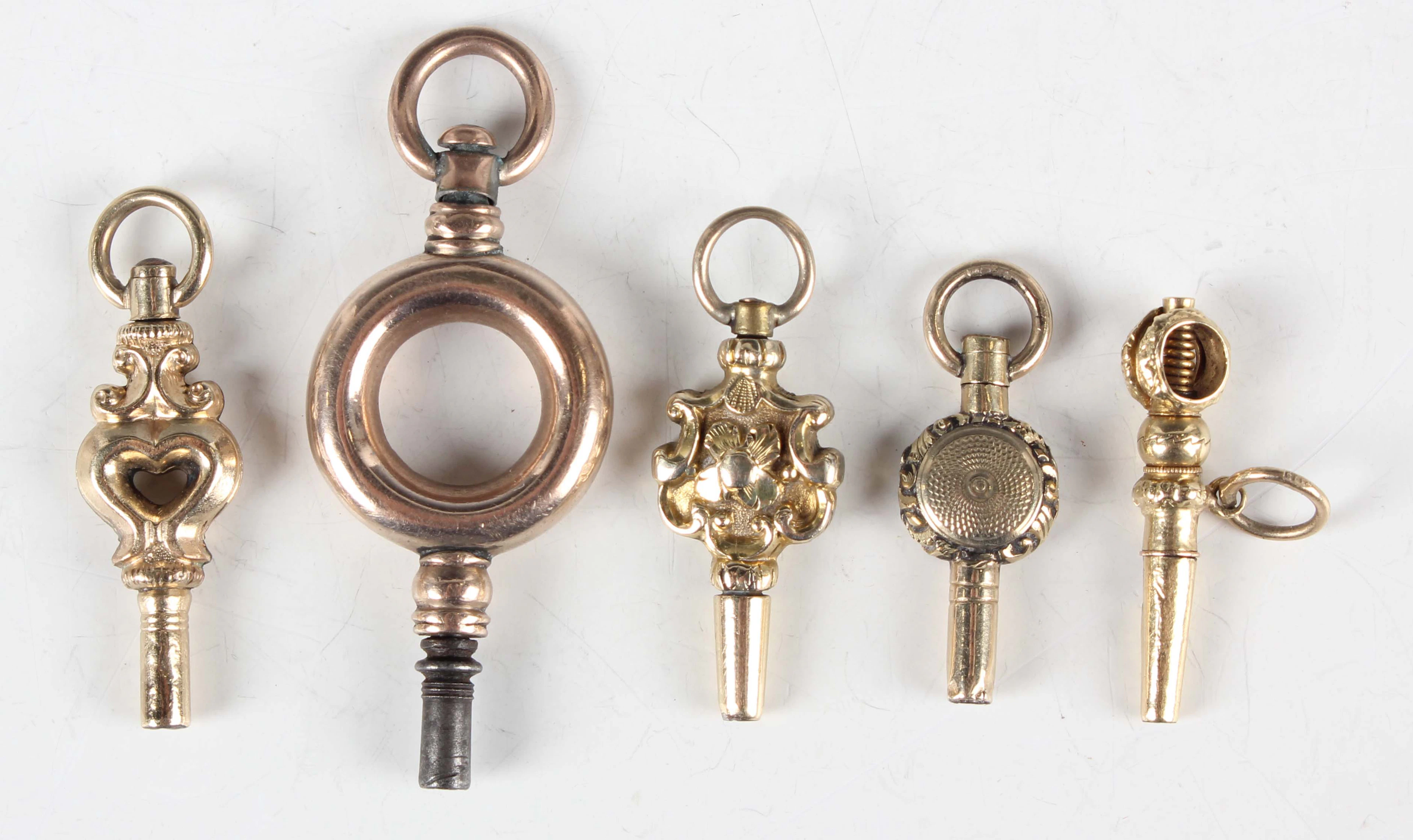 A group of five 19th century gold pocket watch keys of various designs