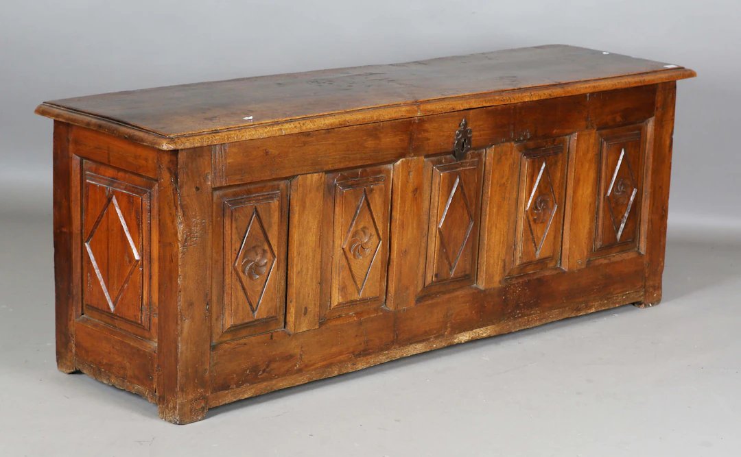 A long 17th/18th century French walnut and fruitwood coffer, the hinged