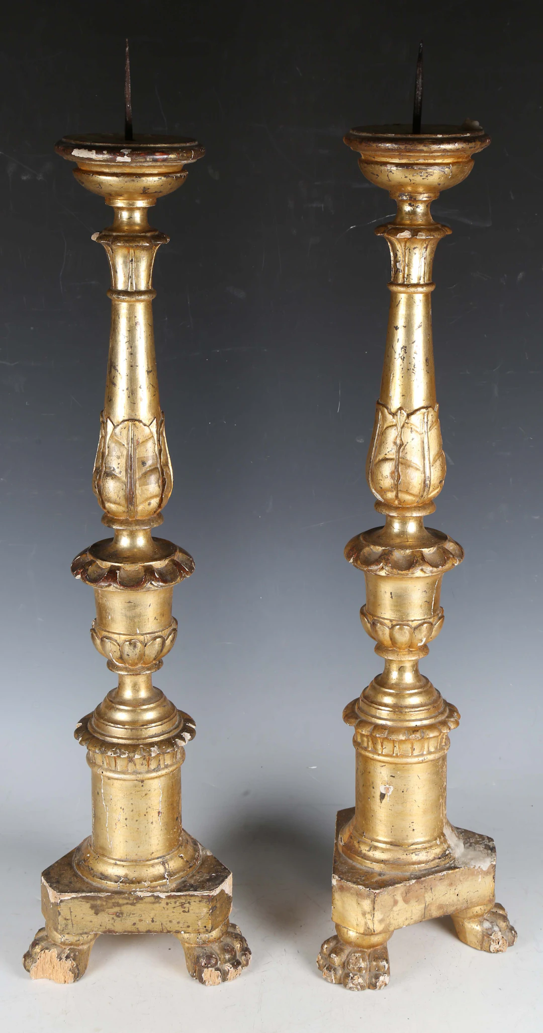 A pair of 19th century Italian giltwood pricket candle stands of carved
