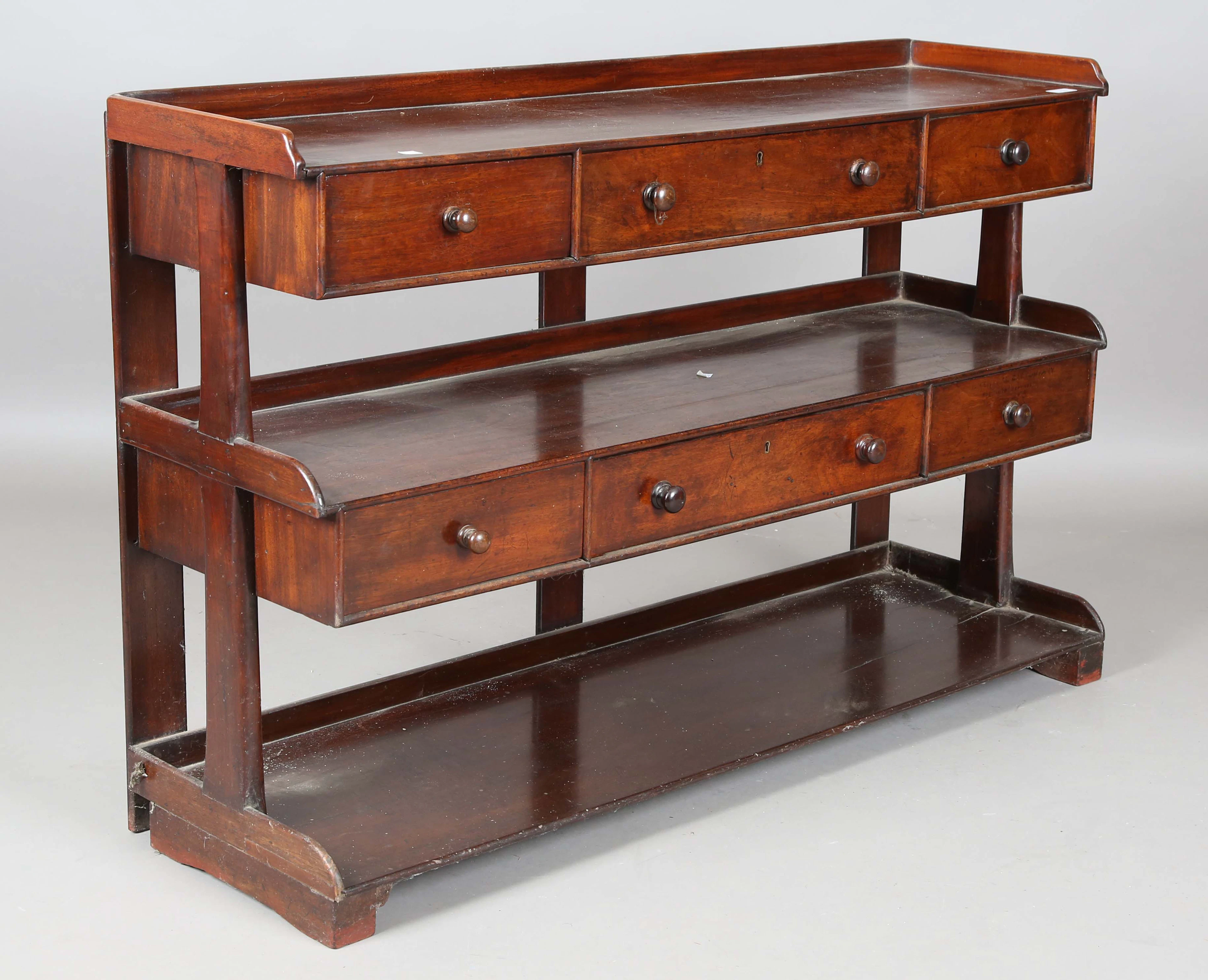 A Victorian mahogany three-tier stand, fitted with six drawers, height