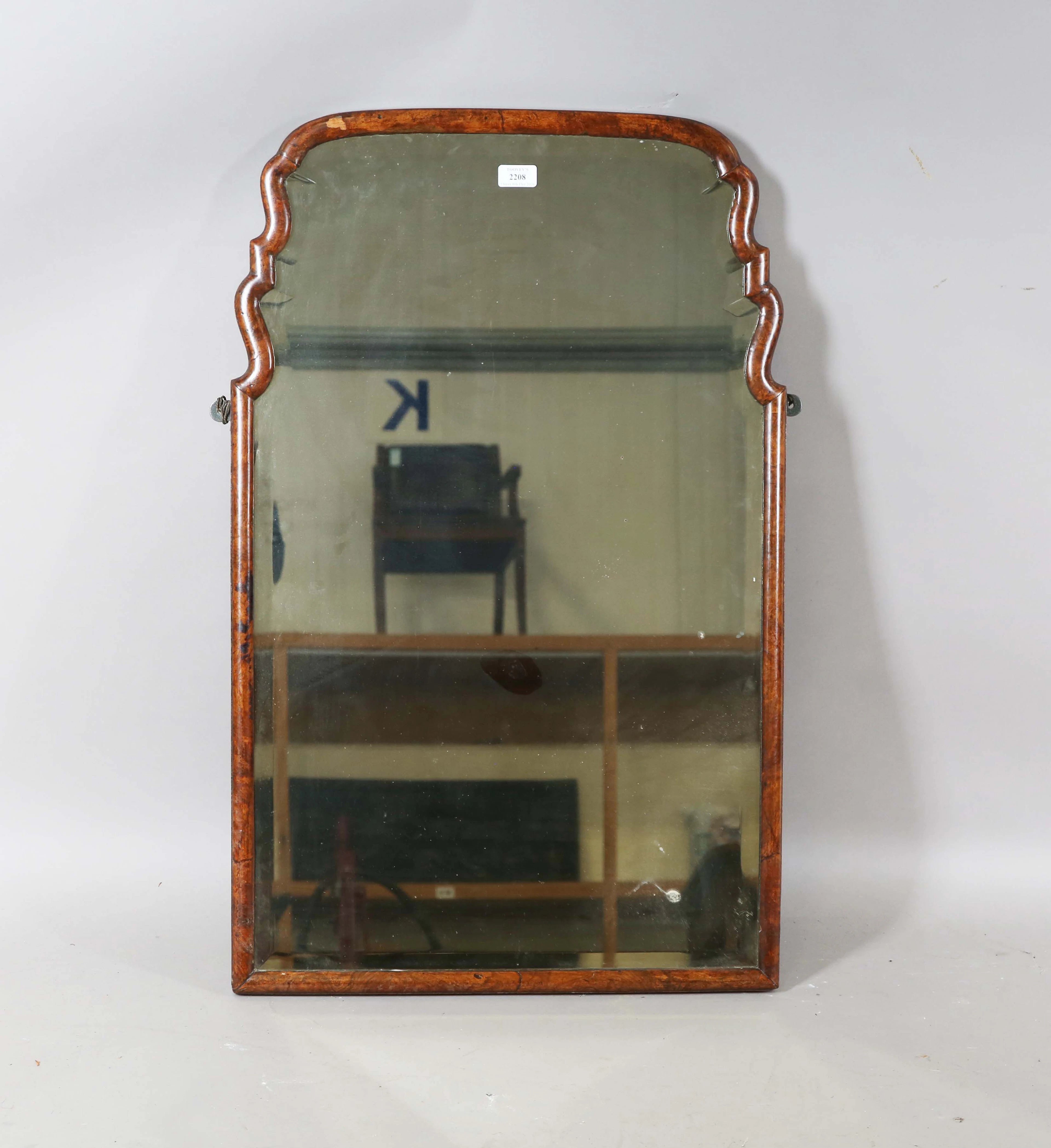 A 19th century Queen Anne style burr walnut arch framed wall mirror
