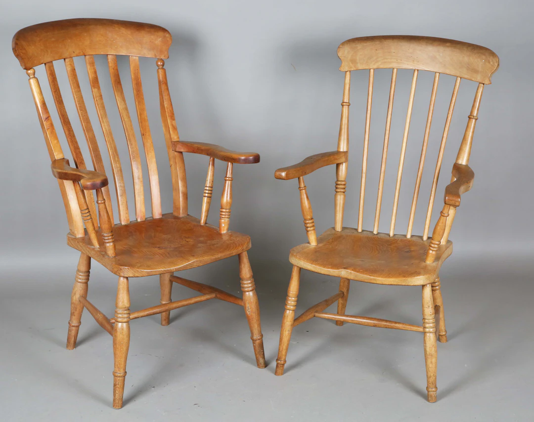 Two late Victorian comb back kitchen armchairs with solid panel seats