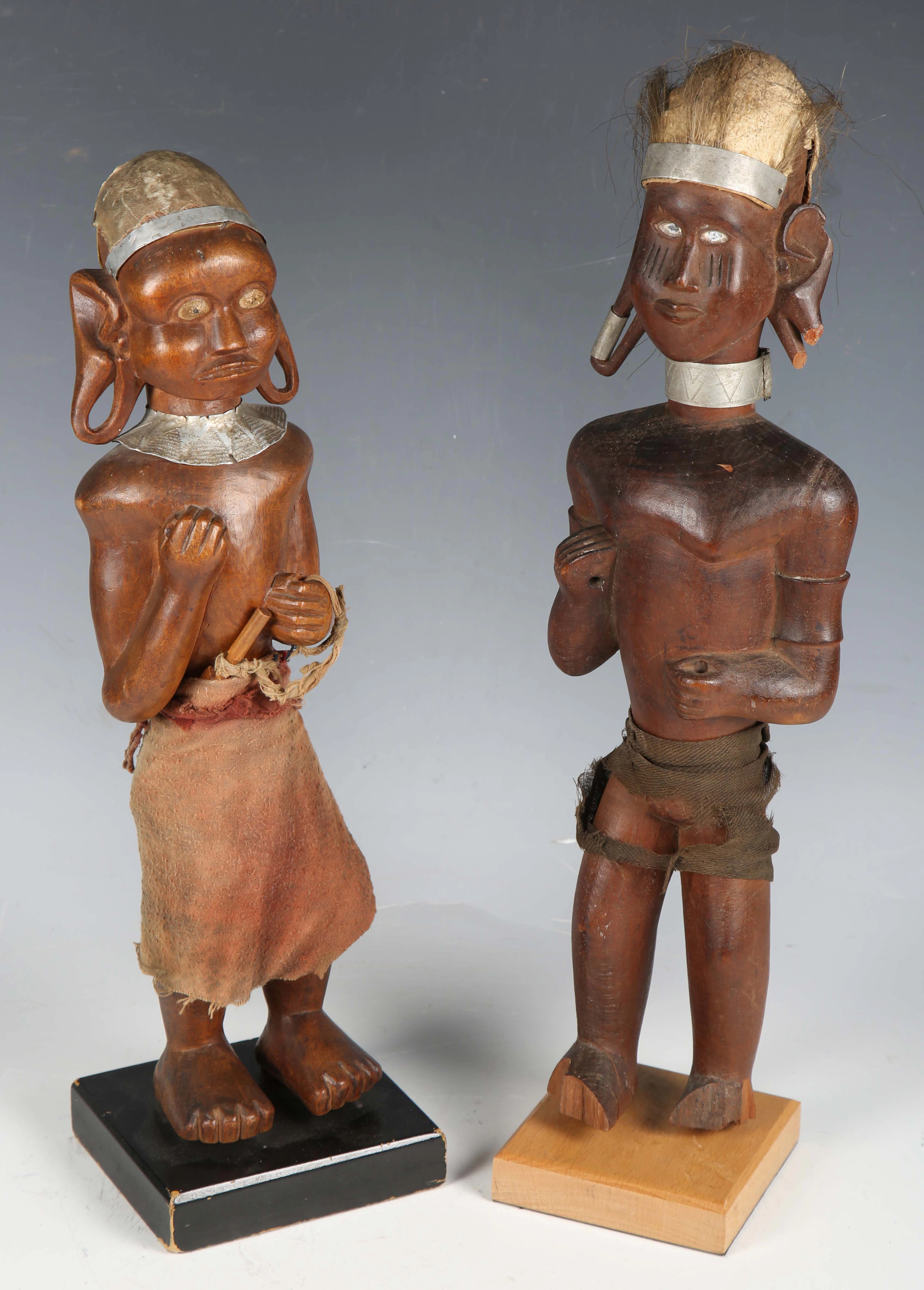 Two early 20th century Kamba carved wooden standing figures of a man