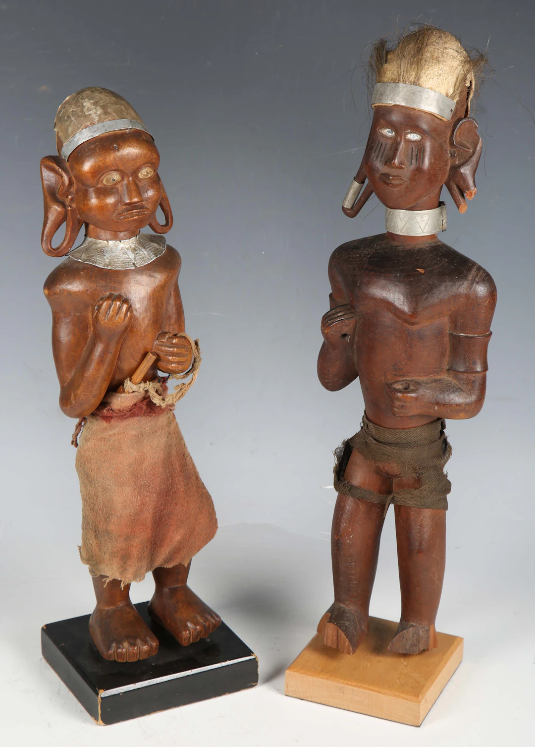 Two early 20th century Kamba carved wooden standing figures of a man