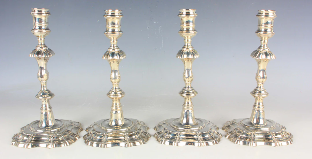 A set of four George II silver candlesticks, each with a cylindrical