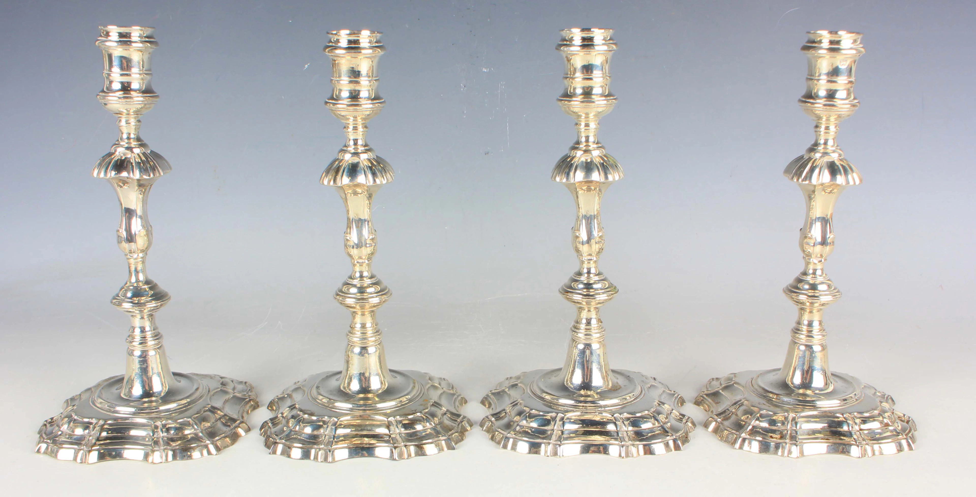 A set of four George II silver candlesticks, each with a cylindrical