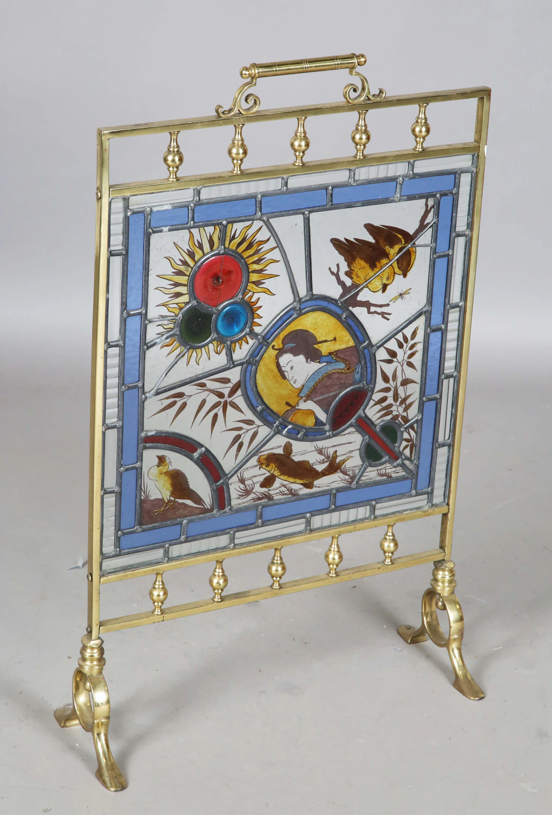 A late Victorian Aesthetic Movement brass framed and stained glass