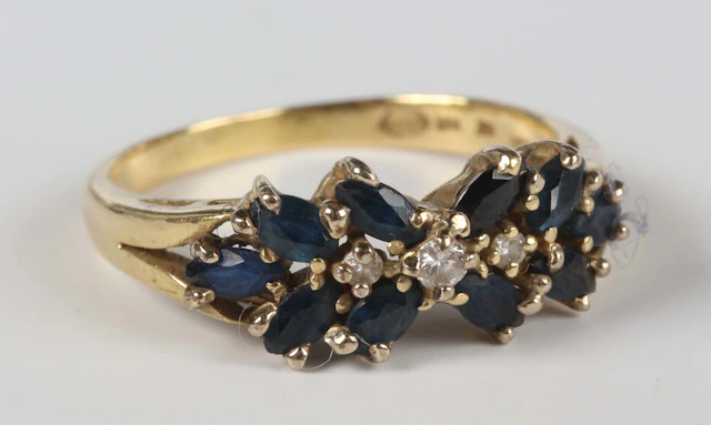 A gold, sapphire and diamond ring, mounted with a row of three graduated
