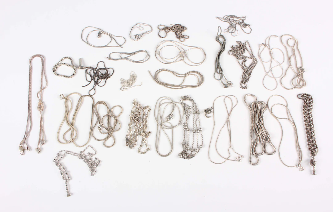 A collection of approximately forty-three neckchains, the majority