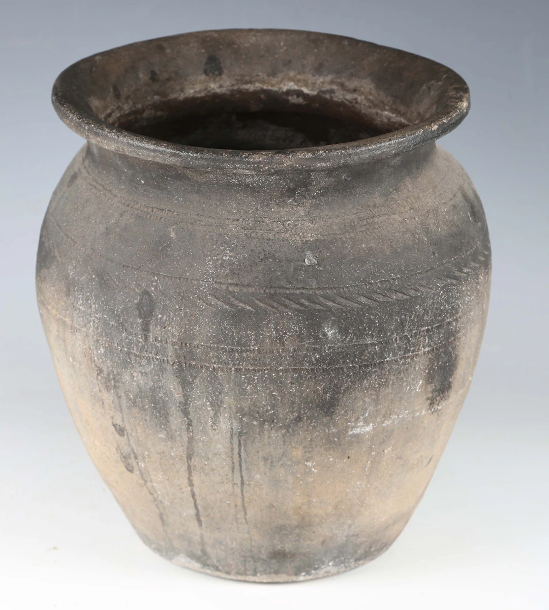 A burnished pottery urn, in the style of a Bronze Age pot, with lightly